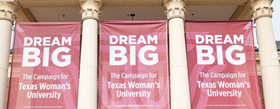 TWU Dream Big campaign photo of students holding signs that spell out "Dream Big" in front of campus building.